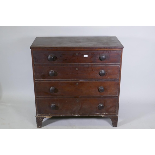 1086 - A Georgian mahogany chest of four long drawers, with cockbeaded detail and wooden knobs, raised on b... 