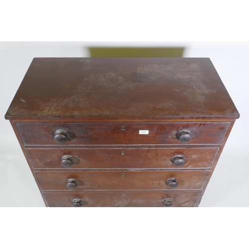 1086 - A Georgian mahogany chest of four long drawers, with cockbeaded detail and wooden knobs, raised on b... 