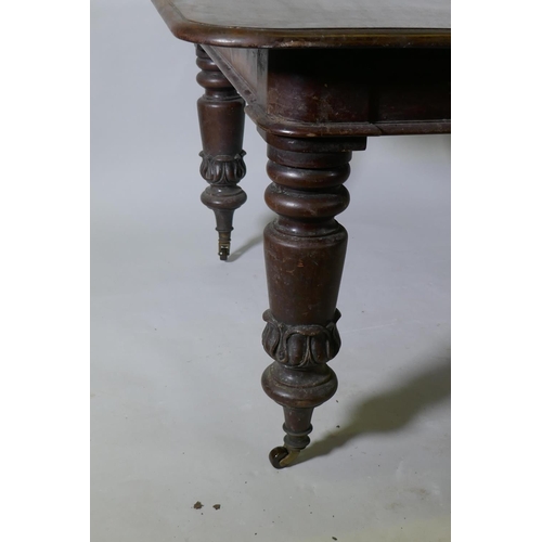 1087 - A Victorian mahogany pull out extending dining table raised on turned supports with carved decoratio... 