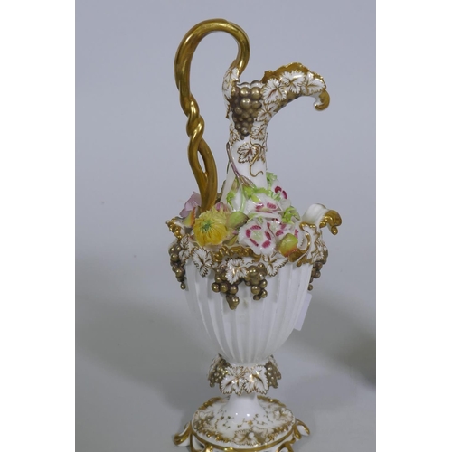 109 - A pair of Continental hard paste porcelain ewers with fine applied floral decoration and gilded high... 