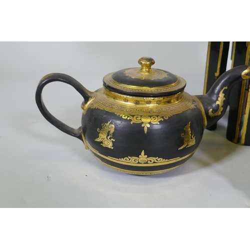 11 - A Burmese black lacquer and gilt table and tea set, table 30cm high