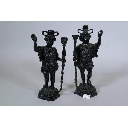 110 - A pair of painted brass figural candlesticks in the form of Moors bearing torches, 40cm high