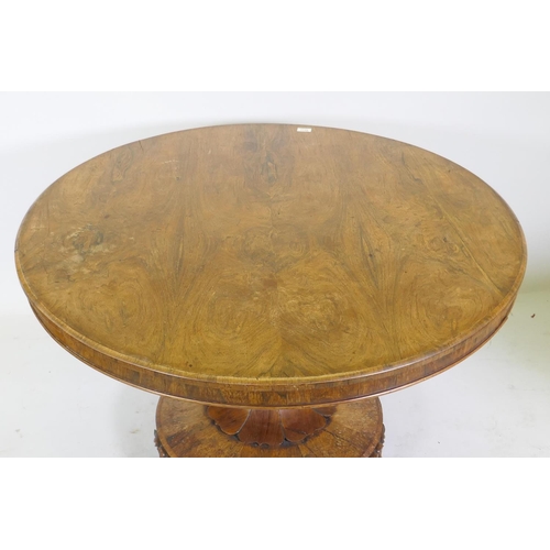 1128 - A C19th rosewood tilt top breakfast table, raised on a shaped column with carved detail and platform... 