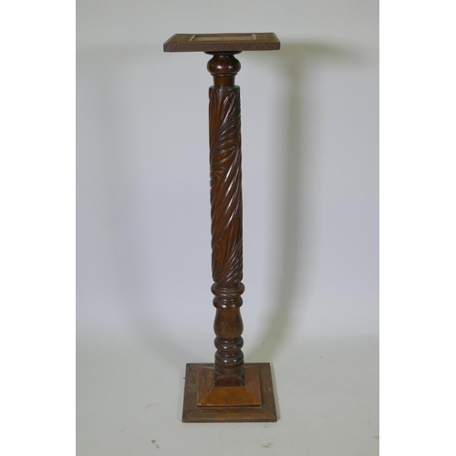 1129 - An antique Anglo Indian hardwood torchere with carved spiral leaf decoration to the column, 110cm hi... 