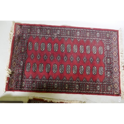 1130 - A Bokhara hand woven wool rug, red ground with traditional pattern, 7 x 157cm