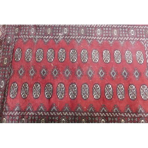 1130 - A Bokhara hand woven wool rug, red ground with traditional pattern, 7 x 157cm