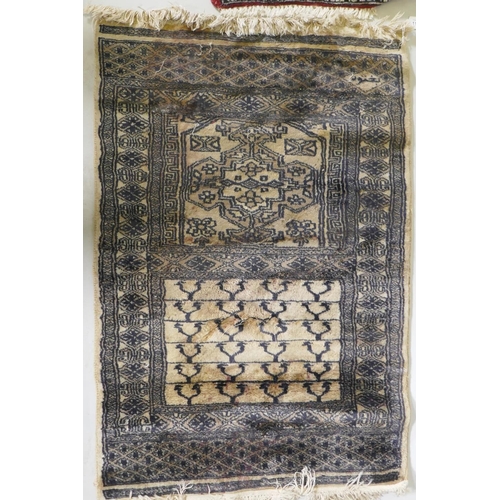 1133 - A hand woven wool Middle Eastern prayer rug, signed, 60 x 90cm, and another smaller