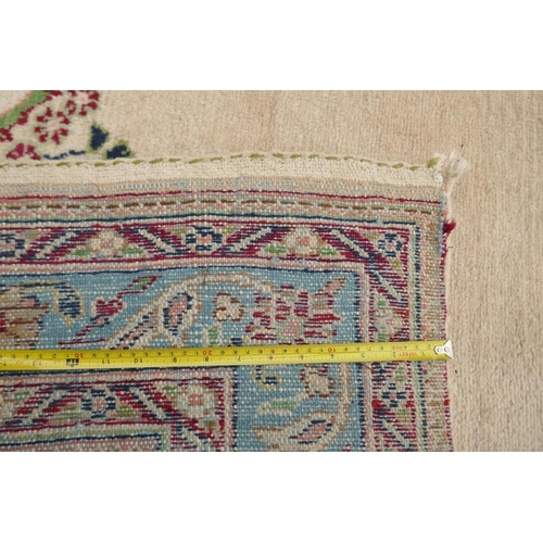 1141 - An Oriental cream ground hand woven wool runner with blue border and floral designs, 150 x 600cm