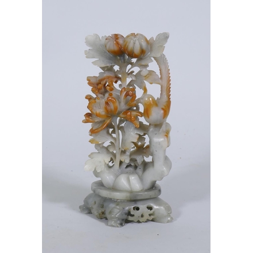 116 - A Chinese carved soapstone ornament, depicting a bird with chrysanthemums, 19cm high