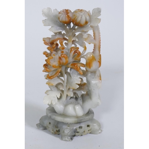 116 - A Chinese carved soapstone ornament, depicting a bird with chrysanthemums, 19cm high