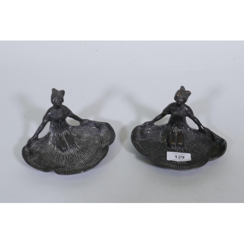 129 - A pair of bronze dishes in the form of kneeling women with fanned skirts, 10cm high