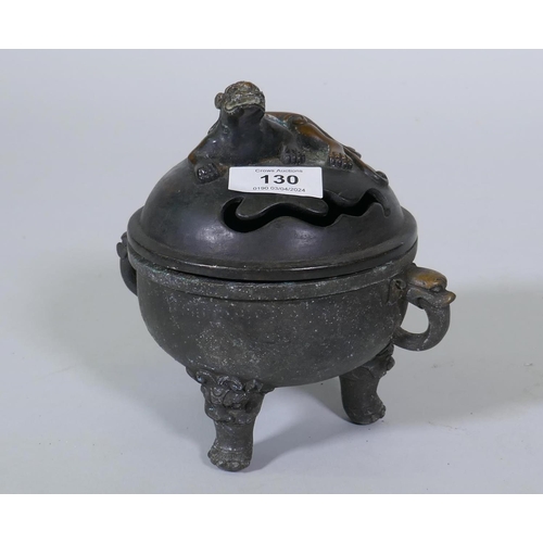 130 - A bronze censer with kylin knop on a bowl with elephant mask handles and dragon supports, 17cm high