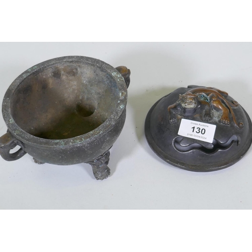 130 - A bronze censer with kylin knop on a bowl with elephant mask handles and dragon supports, 17cm high