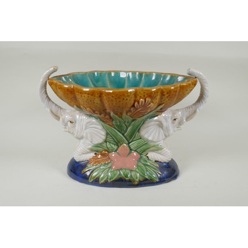 132 - A vintage Majolica centrepiece in the form of two elephants carrying a scalloped bowl