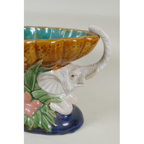 132 - A vintage Majolica centrepiece in the form of two elephants carrying a scalloped bowl