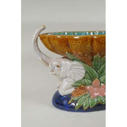 132 - A vintage Majolica centrepiece in the form of two elephants carrying a scalloped bowl