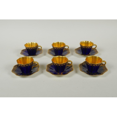 134 - An antique Coalport porcelain cabaret set of six cups and saucers, in cobalt blue and gilt, saucer 9... 