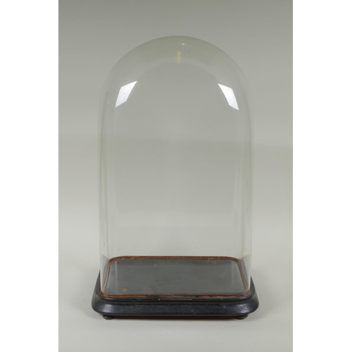 137 - An antique glass clock dome and stand, 30 x 18cm, 47cm high