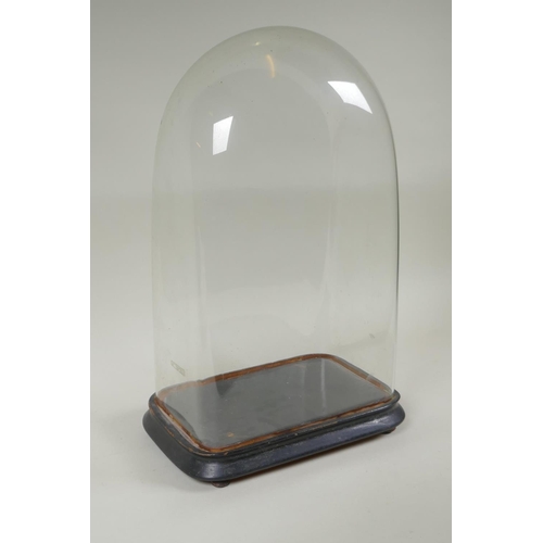 137 - An antique glass clock dome and stand, 30 x 18cm, 47cm high