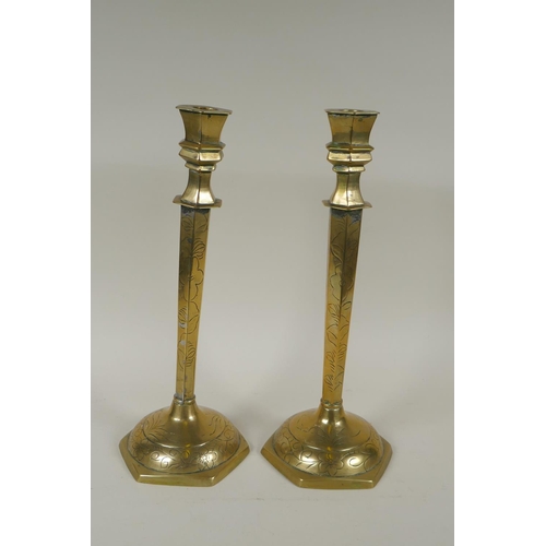 140 - A pair of Chinese brass hexagonal candlesticks with engraved floral decoration, 35cm high