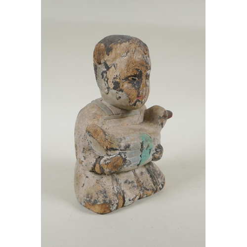 150 - A C19th carved and painted wood figure of a girl carrying a duck, with inset bone eyes, 21cm high