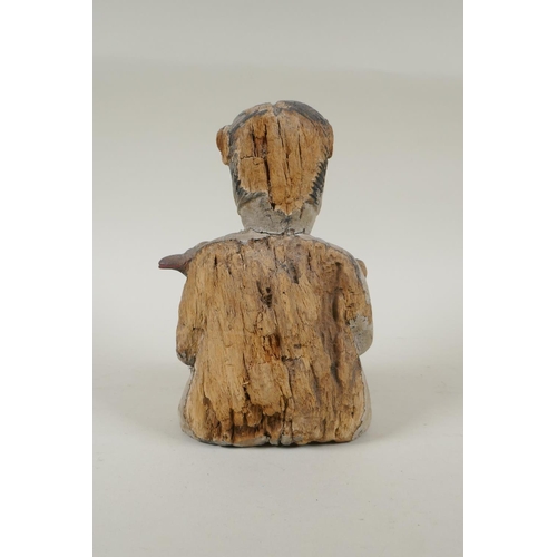 150 - A C19th carved and painted wood figure of a girl carrying a duck, with inset bone eyes, 21cm high