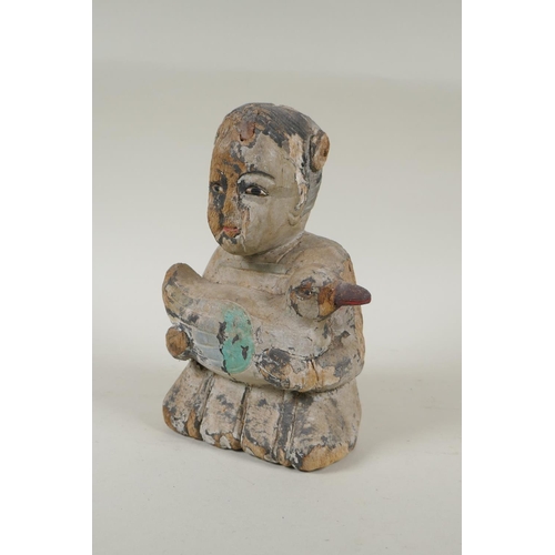 150 - A C19th carved and painted wood figure of a girl carrying a duck, with inset bone eyes, 21cm high