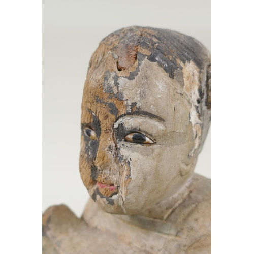 150 - A C19th carved and painted wood figure of a girl carrying a duck, with inset bone eyes, 21cm high