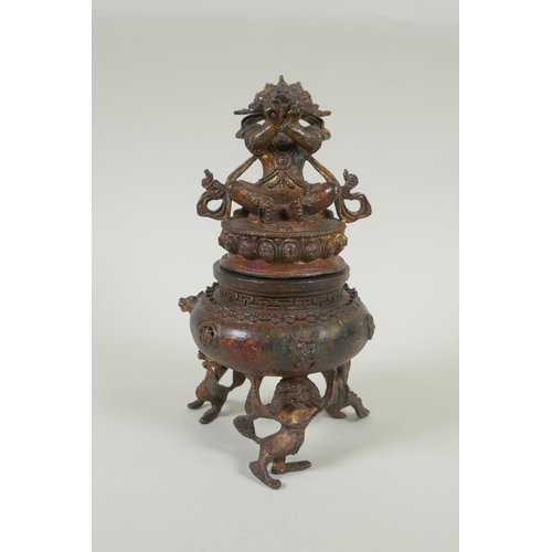 153 - A Tibetan gilt bronze censer and cover, the knop in the form of a wrathful deity, double vajra mark ... 