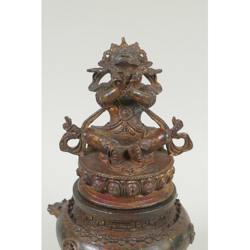 153 - A Tibetan gilt bronze censer and cover, the knop in the form of a wrathful deity, double vajra mark ... 