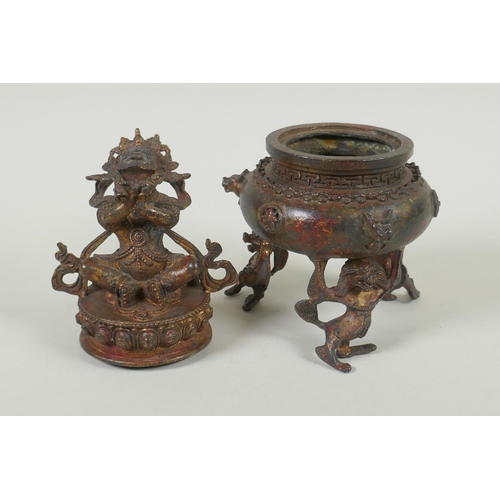 153 - A Tibetan gilt bronze censer and cover, the knop in the form of a wrathful deity, double vajra mark ... 