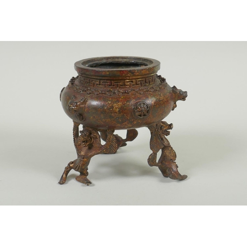 153 - A Tibetan gilt bronze censer and cover, the knop in the form of a wrathful deity, double vajra mark ... 