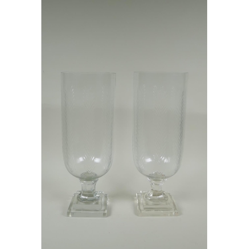 165 - A pair of cut glass hurricane lamps/vases, 40cm high