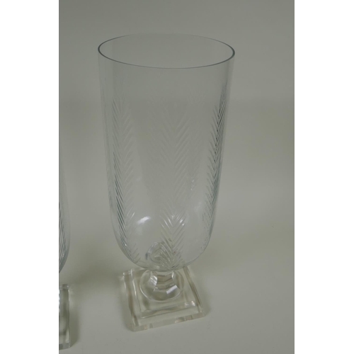 165 - A pair of cut glass hurricane lamps/vases, 40cm high