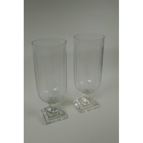 165 - A pair of cut glass hurricane lamps/vases, 40cm high