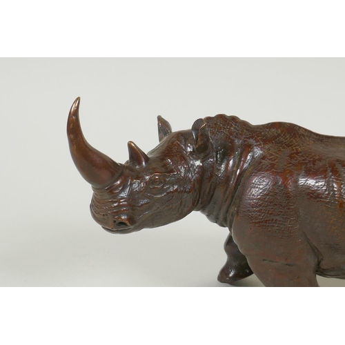 167 - A filled bronze rhinoceros, 23cm long