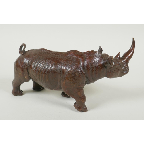 167 - A filled bronze rhinoceros, 23cm long