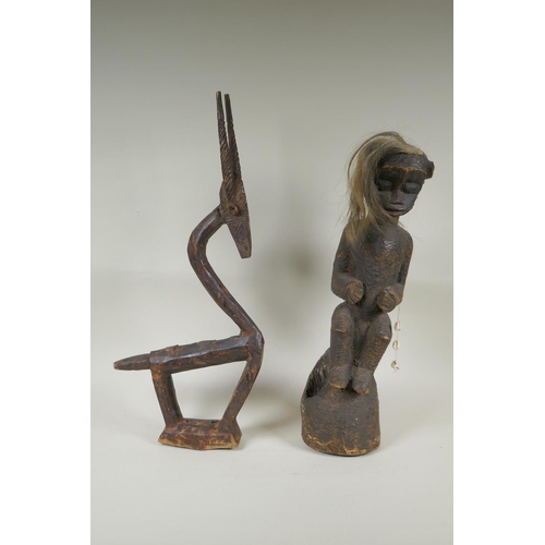 172 - An African Bamana tribe carved wood Chi Wara antelope, together with a carved wood figure with anima... 