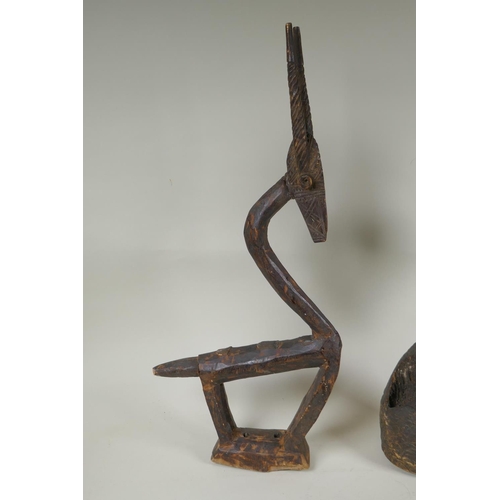 172 - An African Bamana tribe carved wood Chi Wara antelope, together with a carved wood figure with anima... 