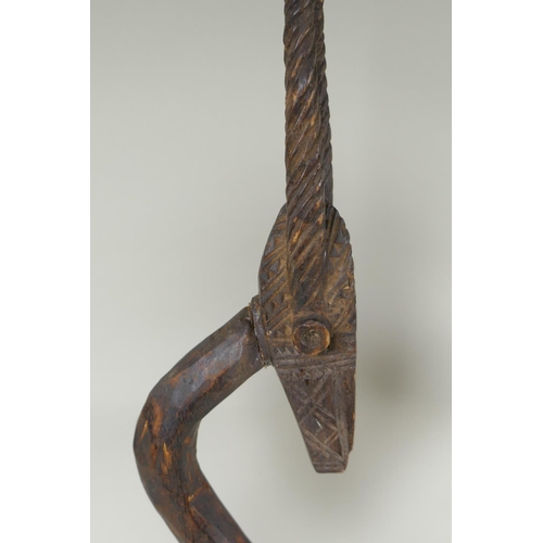 172 - An African Bamana tribe carved wood Chi Wara antelope, together with a carved wood figure with anima... 