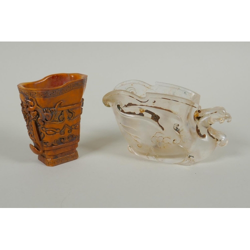 173 - A Chinese moulded glass libation cup in the form of a phoenix, and a carved bone libation cup with a... 