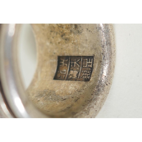 175 - A Chinese white metal archers thumb ring with revolving mount, decorated with auspicious symbols, an... 