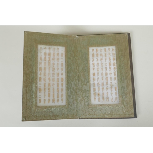 178 - A Chinese wood and silk bound book with white jade tablets bearing chased and gilt inscriptions, 22 ... 