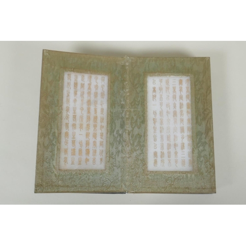 178 - A Chinese wood and silk bound book with white jade tablets bearing chased and gilt inscriptions, 22 ... 