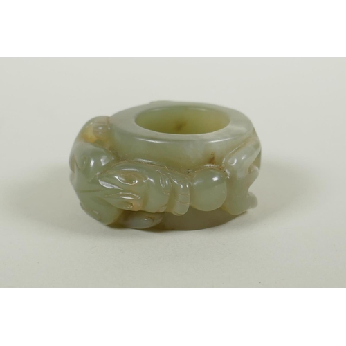 181 - A Chinese carved celadon archers thumb ring, with kylin decoration, 5cm diameter