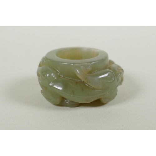 181 - A Chinese carved celadon archers thumb ring, with kylin decoration, 5cm diameter