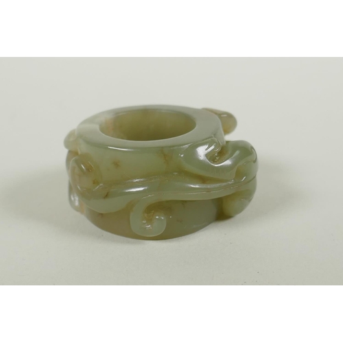 181 - A Chinese carved celadon archers thumb ring, with kylin decoration, 5cm diameter