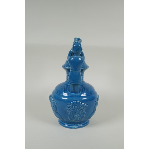 183 - A Chinese teal glazed porcelain pourer decorated with Fo dogs and figures, mark to base, 29cm high