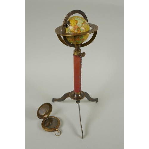 186 - A brass and leather miniature terrestrial globe desk stand, and a replica brass compass, 27cm high