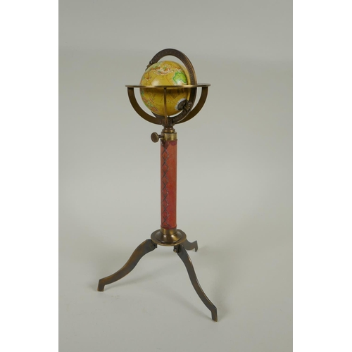 186 - A brass and leather miniature terrestrial globe desk stand, and a replica brass compass, 27cm high